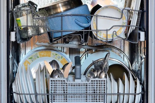 overloaded dishwasher with full of dirty dishes and container which consider as common dishwasher mistake all we have done