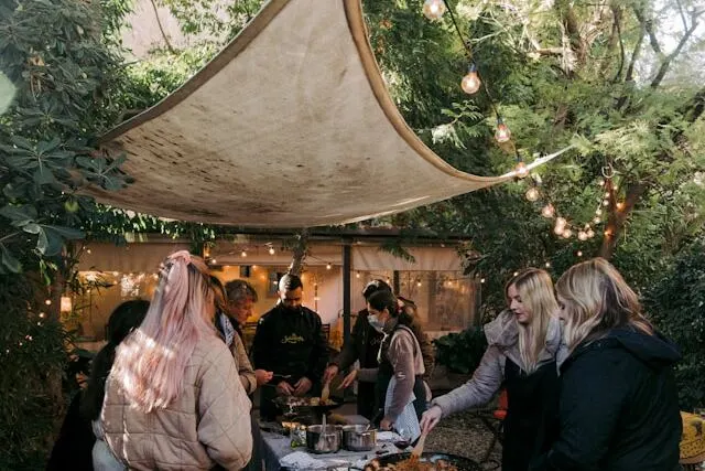hanged shades up to the trees, for outdoor cooking and gathering is one of easiest and doable Summer Outdoor Party Ideas