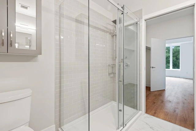 a bathroom with clean glass shower doors