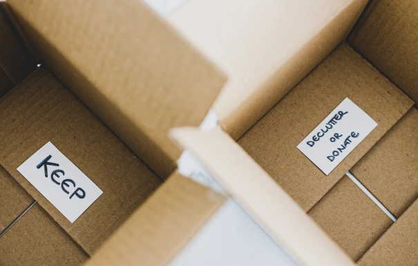 storage boxes to sort between objects to keep and those to declutter or donate with labels