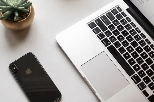 phone beside laptop is one of home office distraction while you working