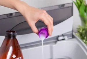 pouring detergent in to washing machine